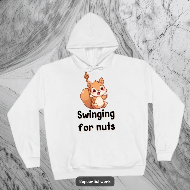 Funny squirrel hoodie featuring a kawaii character swinging from a thick rope, cozy, cute, and humorous.