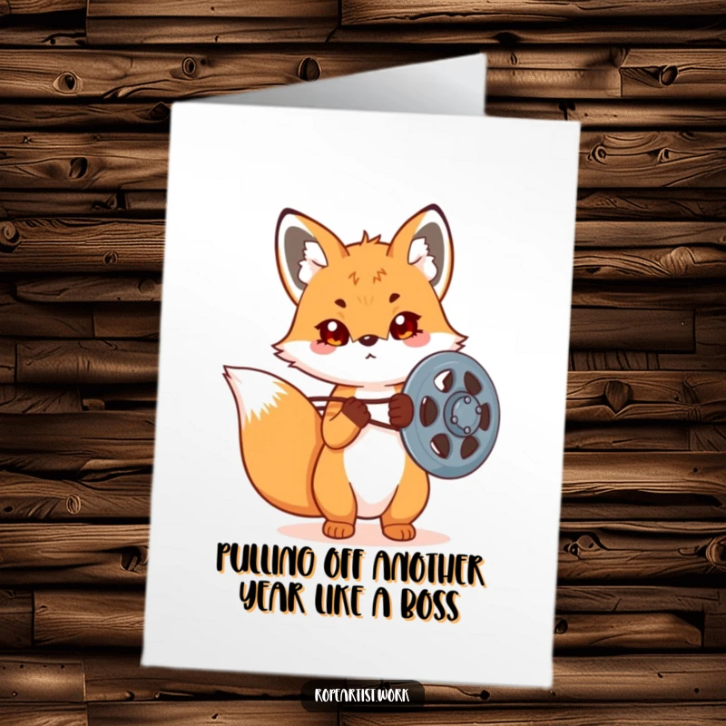 Funny free printable birthday card: Determined kawaii fox adjusting a large pulley, ready for any challenge.